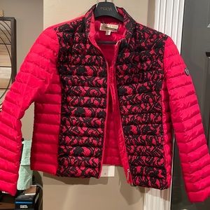 Red Michael Kors winter jacket pleated throughout. Black lace over front.